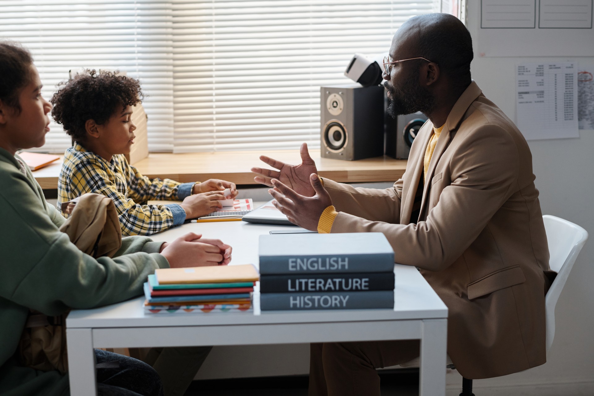 Teacher having conversation with school children